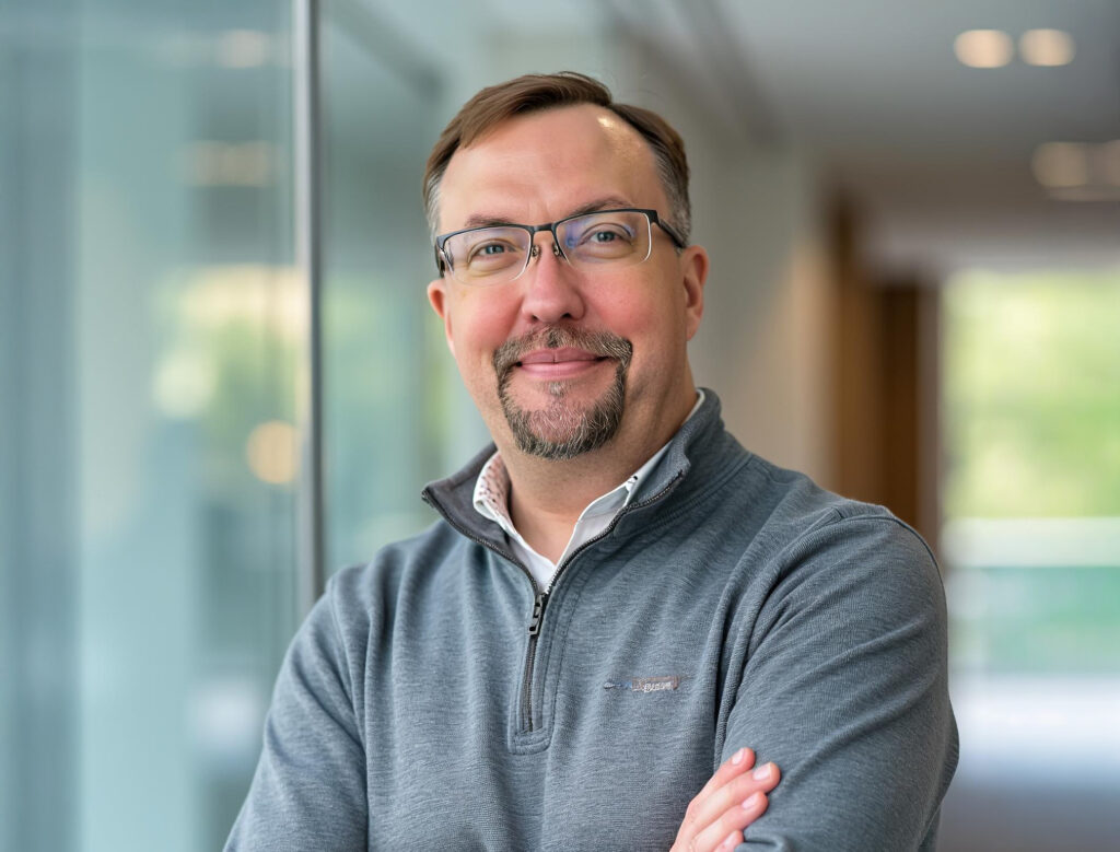 Professional headshot of Jens in a corporate setting